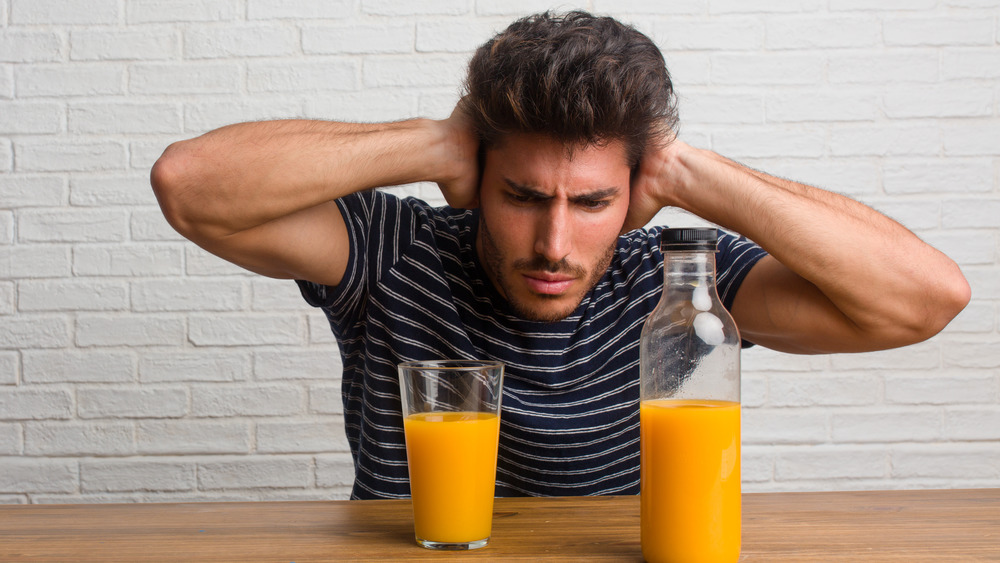 man ignoring orange juice