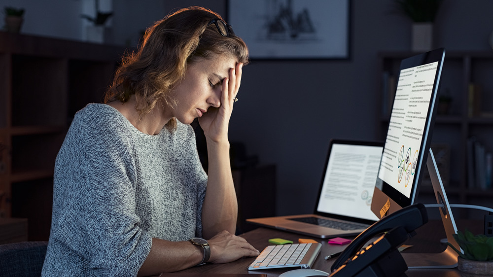 woman fatigued in front of computer