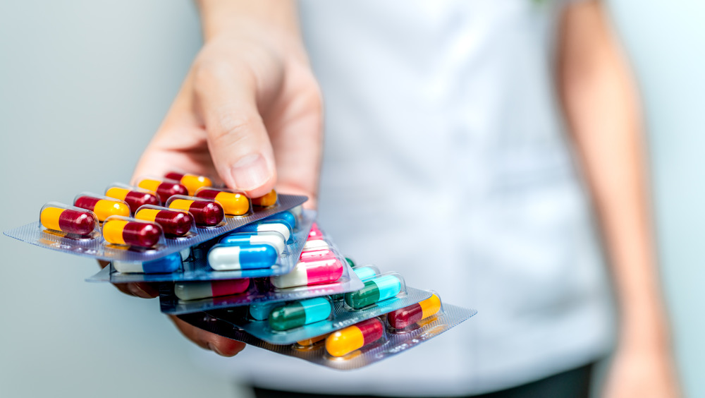 person holding pills in blister packs