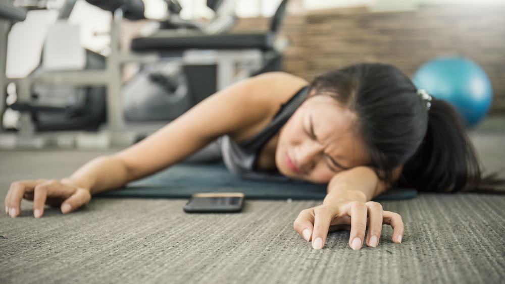 exercising woman on floor exhausted