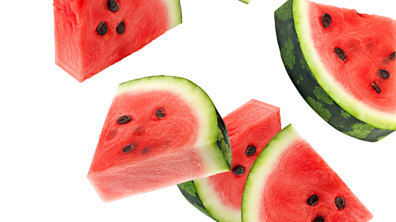watermelon slices falling on a white background