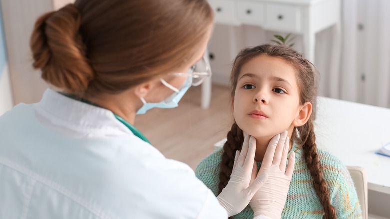 little girl being examined by doctor in clinic