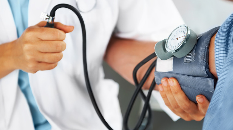 Doctor measuring patient blood pressure