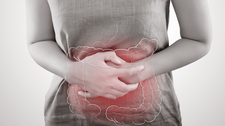 Woman holding large intestine in pain
