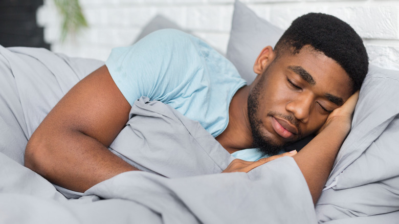 black man resting in bed