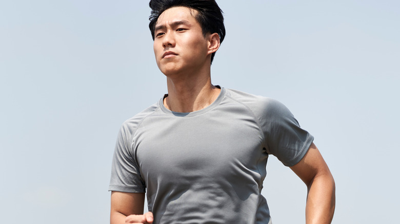 young Asian man running