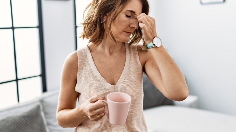 frustrated woman drinking beverage