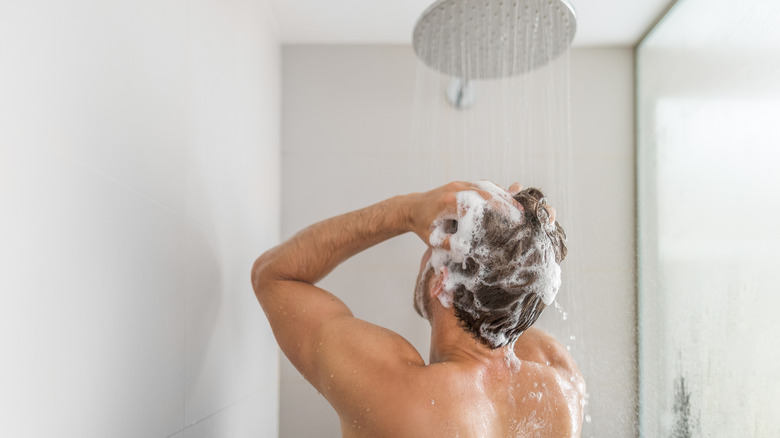 Man shampooing hair