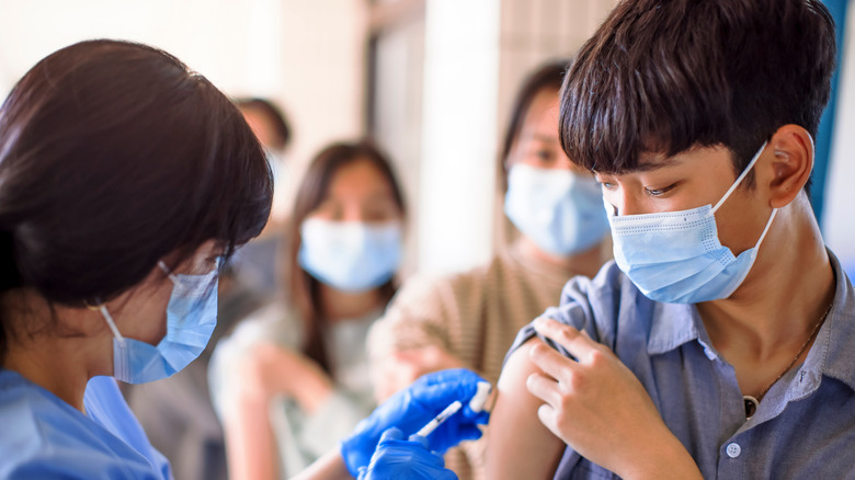 Teenagers standing in line for a vaccine