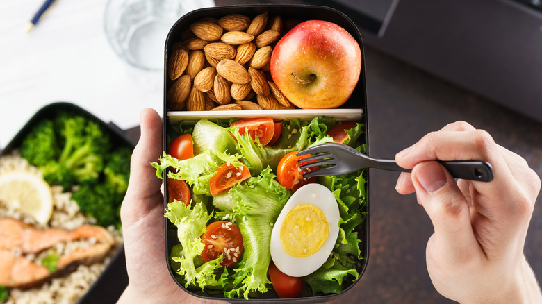 person eating healthy packed lunch