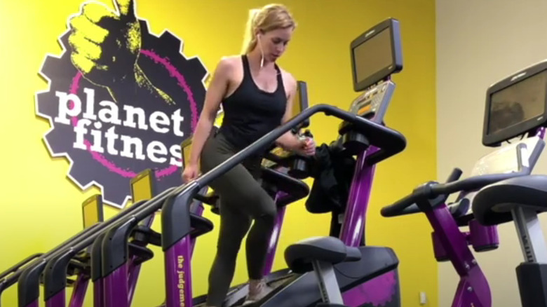 young woman doing side steps on a StairMaster