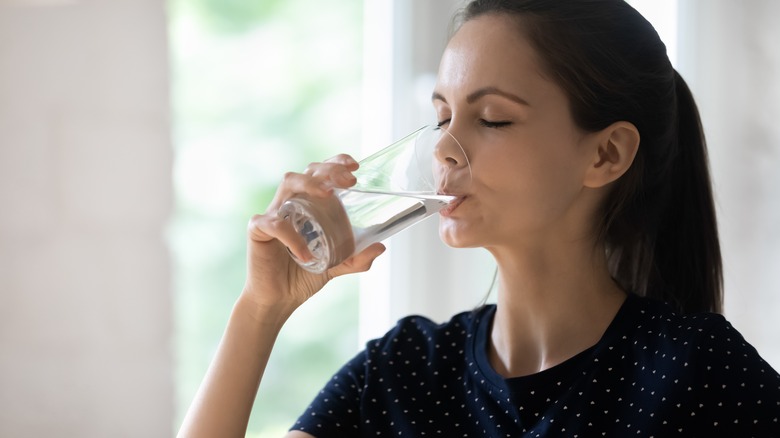 woman swallowing water