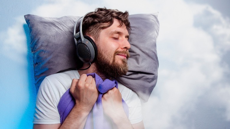 man asleep wearing headphones