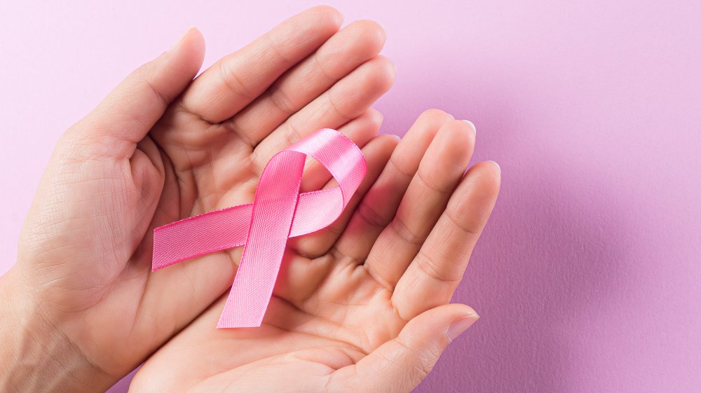 Woman holding breast cancer ribbon