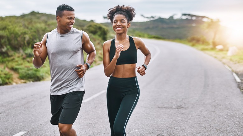 couple happily running outdoors