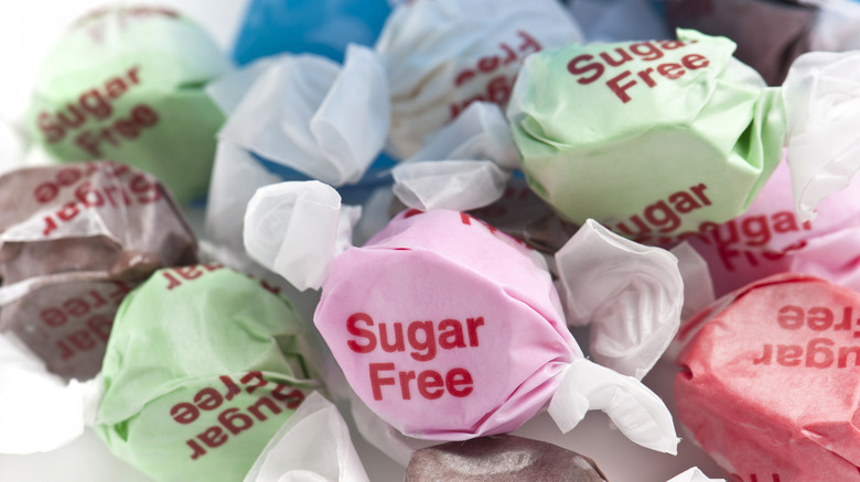 Sugar-free wrapped soft candies on a white background