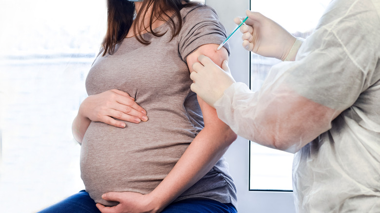 pregnant woman receiving a shot