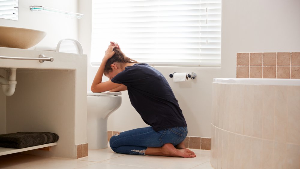 woman sick in bathroom