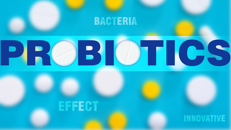 The word "probiotics" against a light blue background with pills