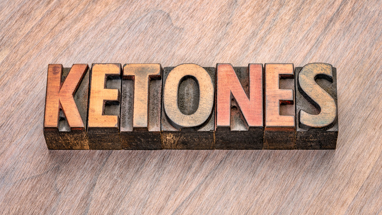 The word "ketones" spelled out with wooden blocks