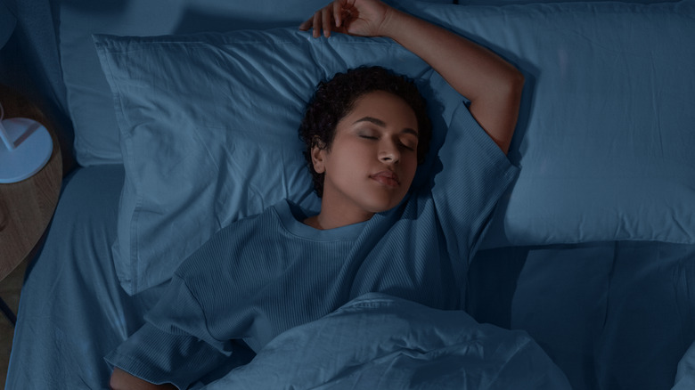 woman sleeping with arm raised