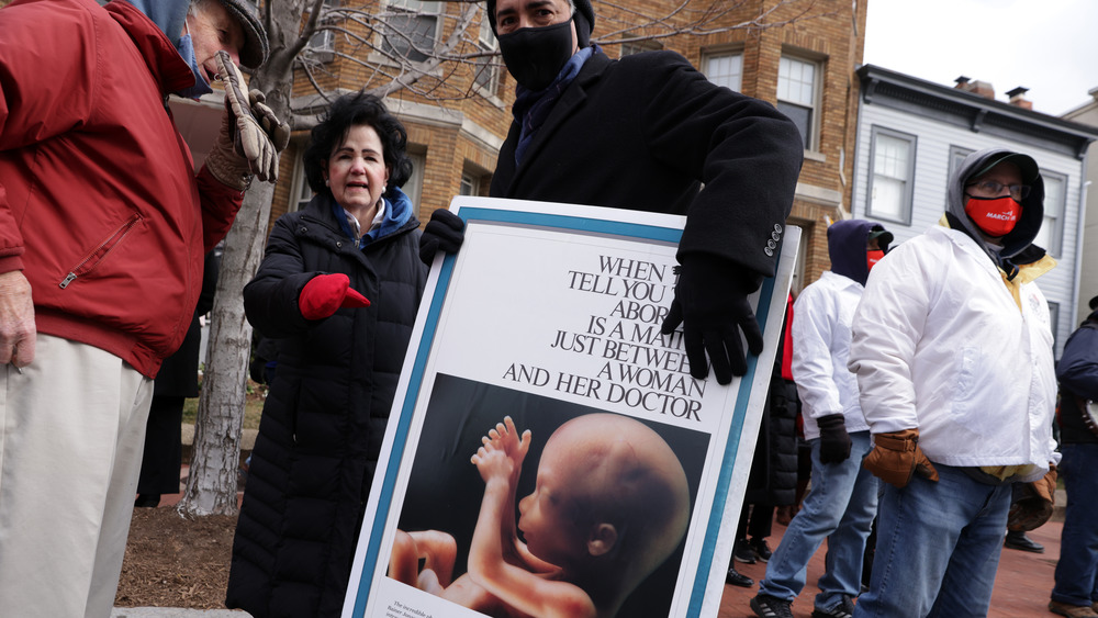 Anti-abortion protesters with sign