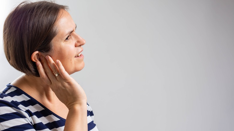 woman struggles to hear
