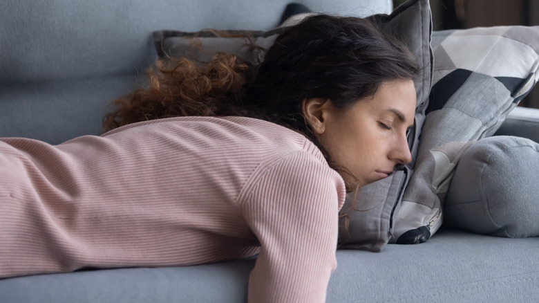 Woman laying face down on couch 