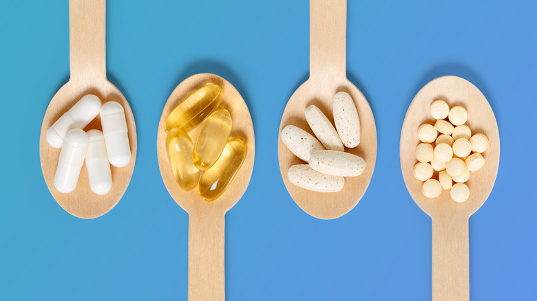 Wooden spoons holding different pills