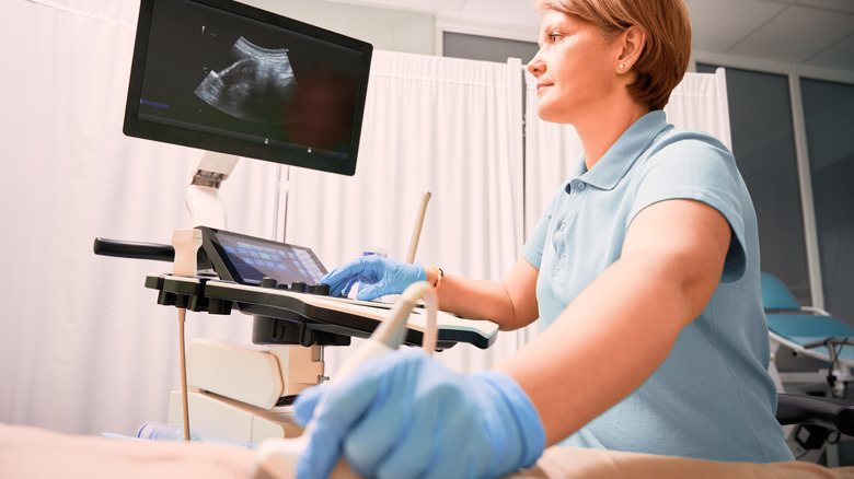 woman performing ultrasound on female patient