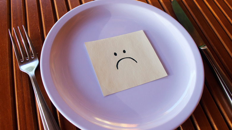 Plate with sad-faced post-it