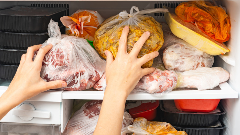 Meat being rearranged in freezer