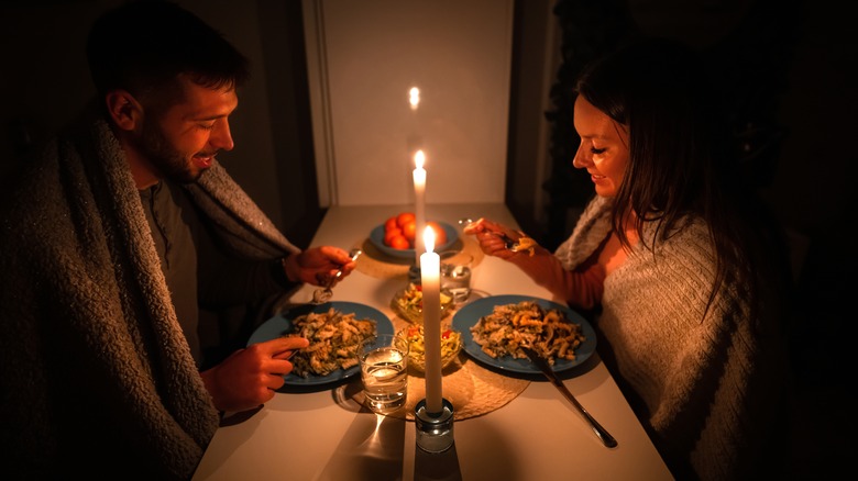 Couple eating meal at home during power outage