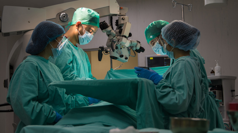four doctors performing sugery