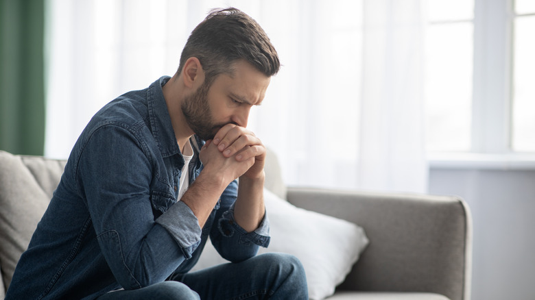 sad man sitting on couch