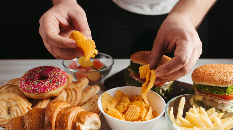 Person eating junk food and sweets