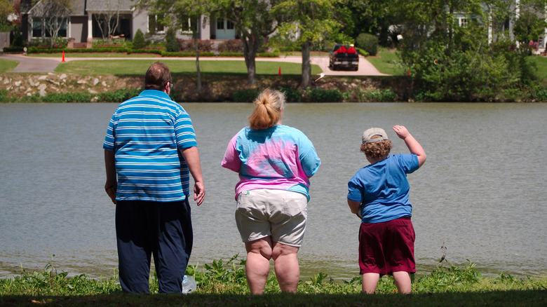 Obese parents and their child having fun outdoors