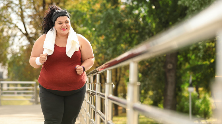 Obese woman jogging outdoors