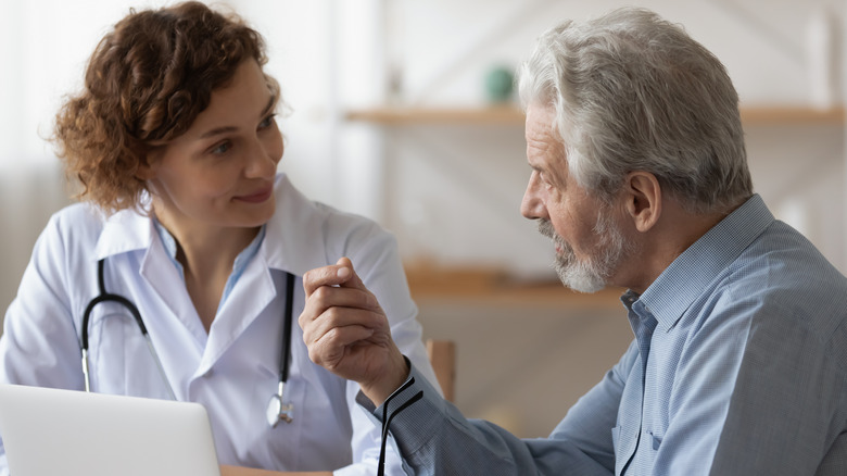 female doctor talking to older patient