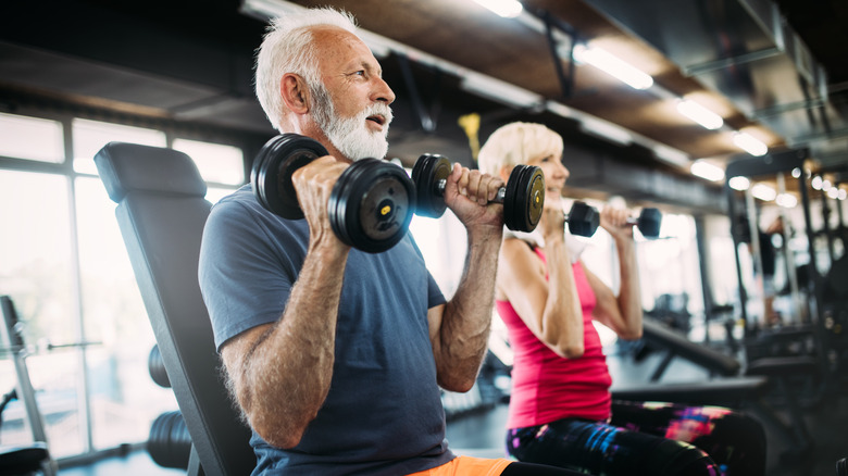 Seniors lifting weights in the gym