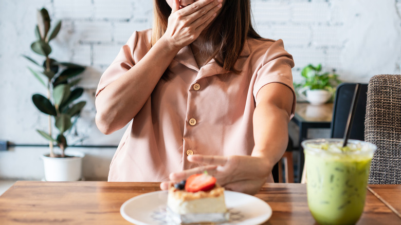 Woman turning down dessert