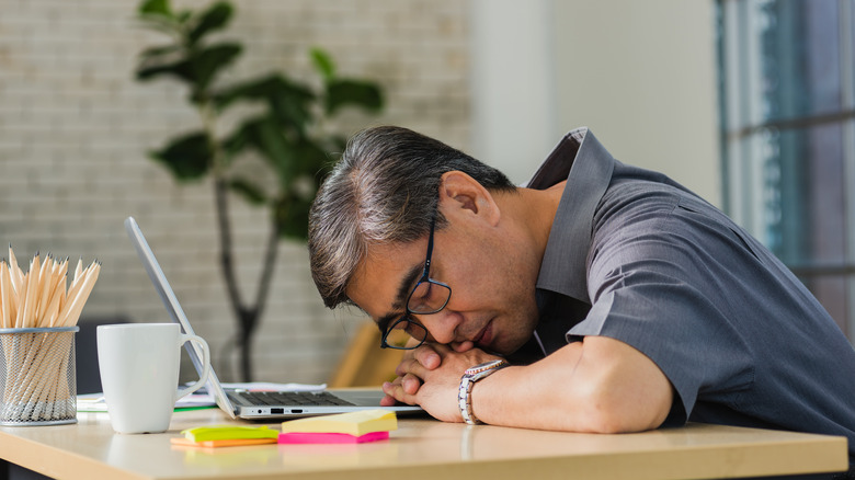 man sleeping desk