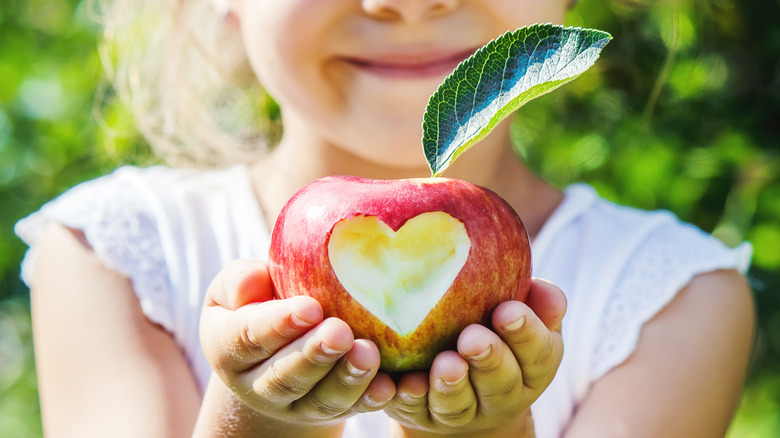 child biting apple