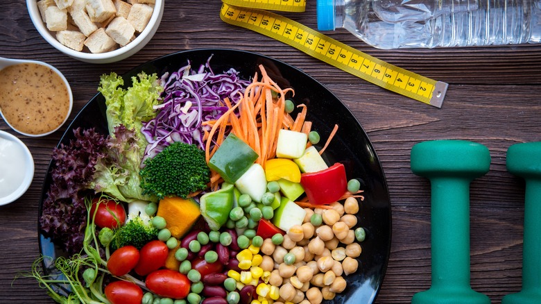 Flat lay of healthy food items and exercise equipment