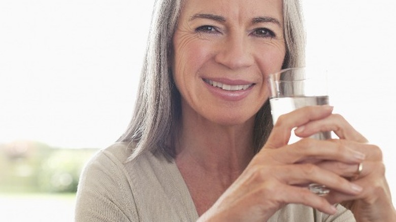 Older woman drinking glass of water