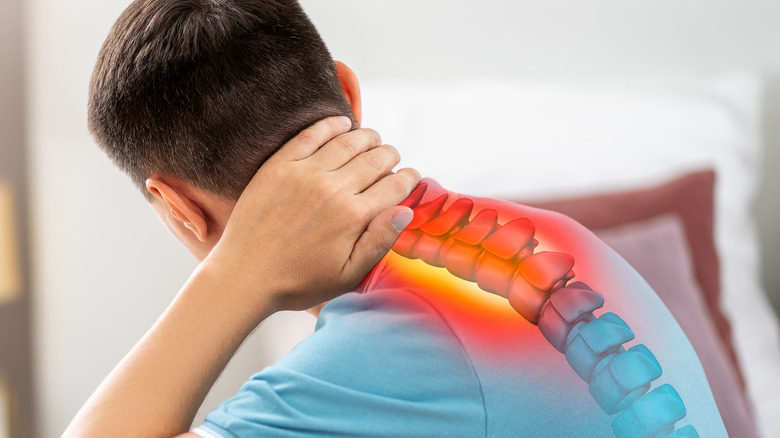 Man holding neck with spine graphic