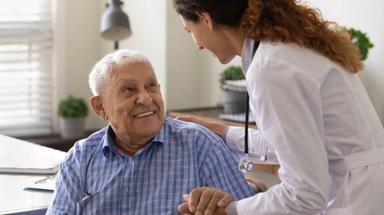 Doctor holding patient's hand