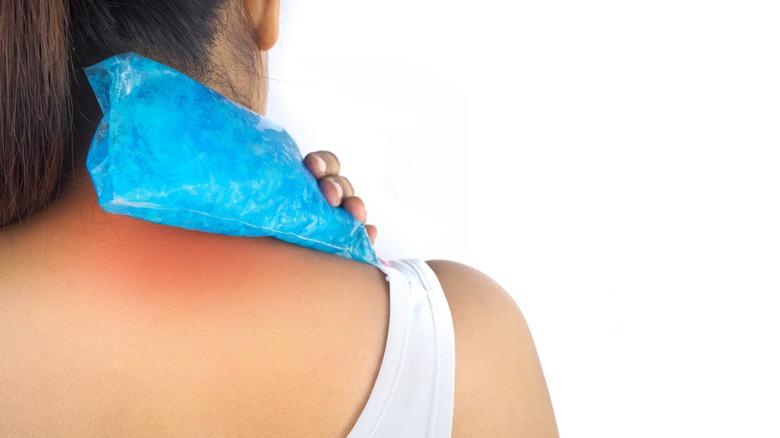 Woman with ice pack on neck