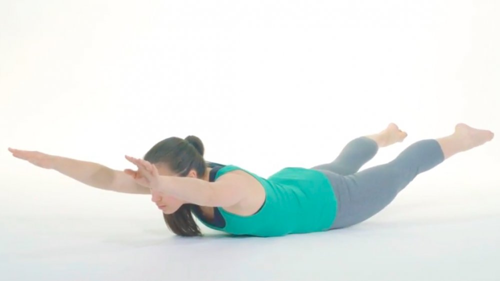 woman performing superman stretch