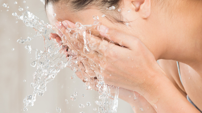 Woman washing her face